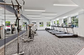 A gym with treadmills and elliptical machines